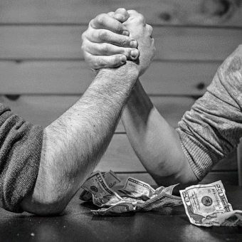 Two men arm wrestling. 