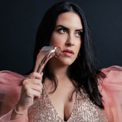 Woman rolling a cold roller on her face. 