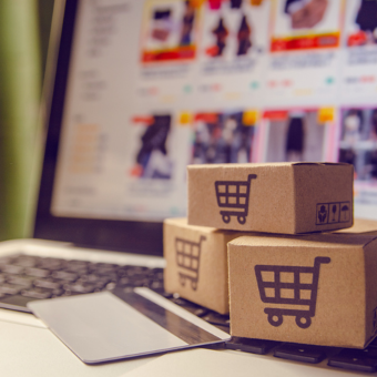 Stack of small boxes in front of a laptop. 