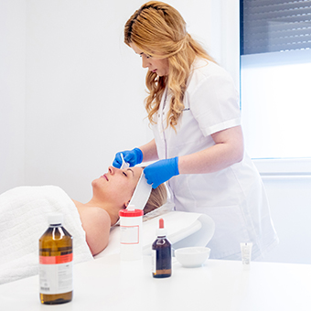 Esthetician applying a facial. 