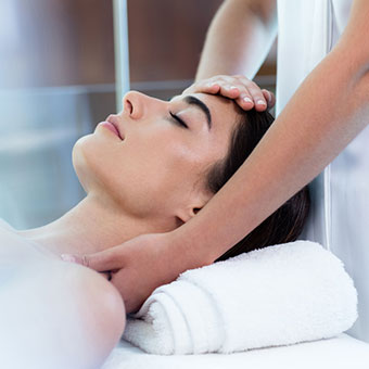 A woman receiving a facial massage from an ASCP esthetician.