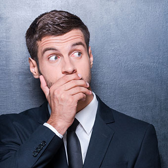 A man showing the results of his eyebrow waxing from an ASCP skincare professional.