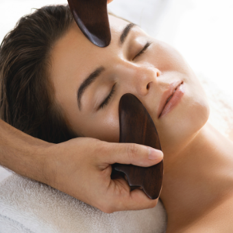 woman receives Gua Sha