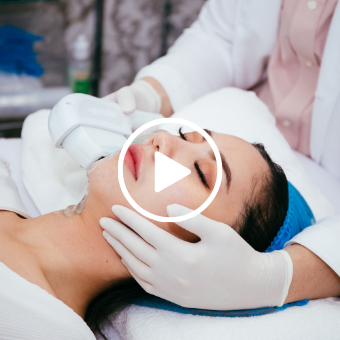 Esthetician performing microblading — Microblading eyebrows with play button overlay 