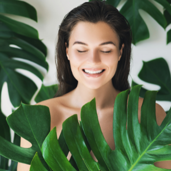 woman surrounded by palm leaves