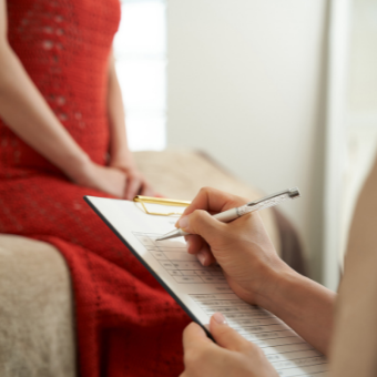 Women fills out informed consent with esthetician