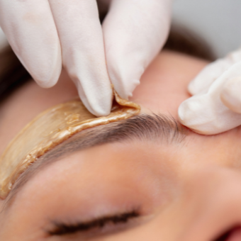 esthetician performs an eyebrow wax