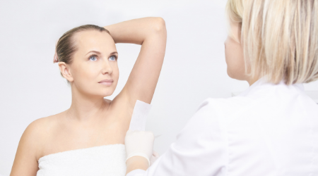 esthetician performs an underarm wax