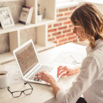 women reviewing numbers on her computer