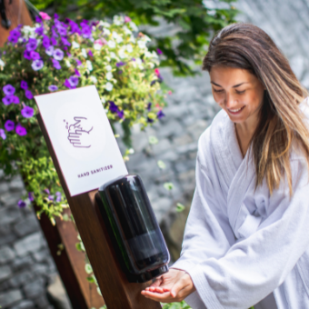 woman using hand sanitizer