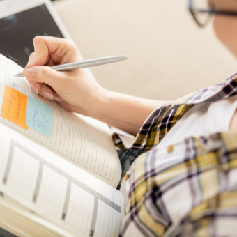 woman writing down her goals in a journal