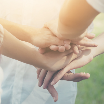 Business colleagues join hands in teamwork